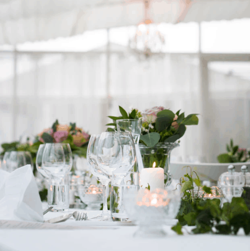 wedding table setup with floral centerpieces and candles