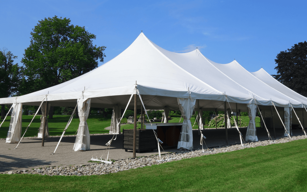 Tent setup with white event tents and canopies for rent in Los Angeles, CA, arranged on a grassy outdoor venue for a wedding or special event.