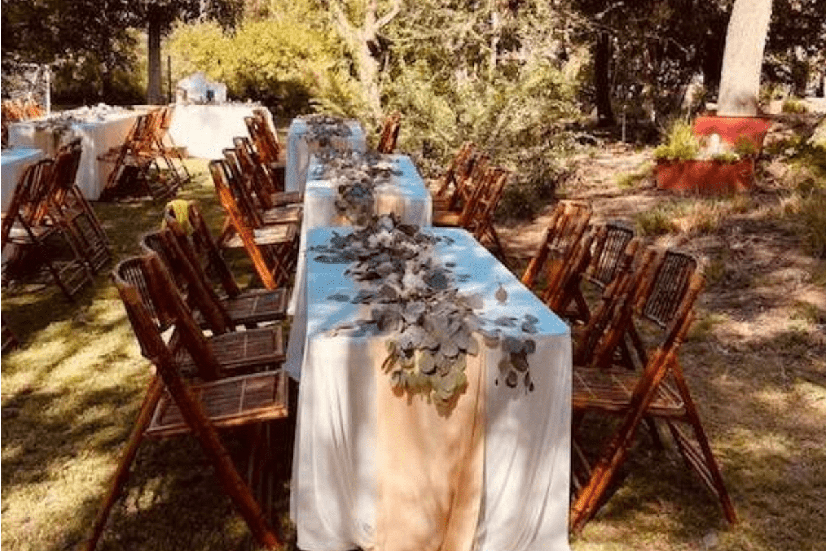 Rustic outdoor table setup with wooden chairs and natural décor in Los Angeles